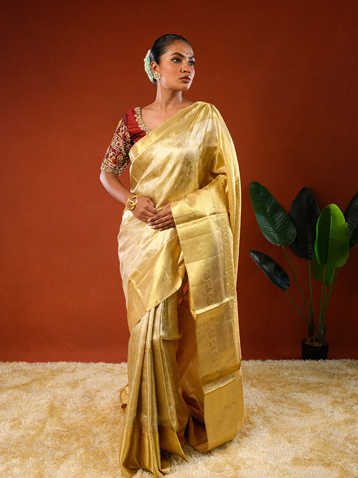 Model wearing Ichchhapuron's Sona saree, a tissue kanjeevaram with a broad golden border and traditional weave