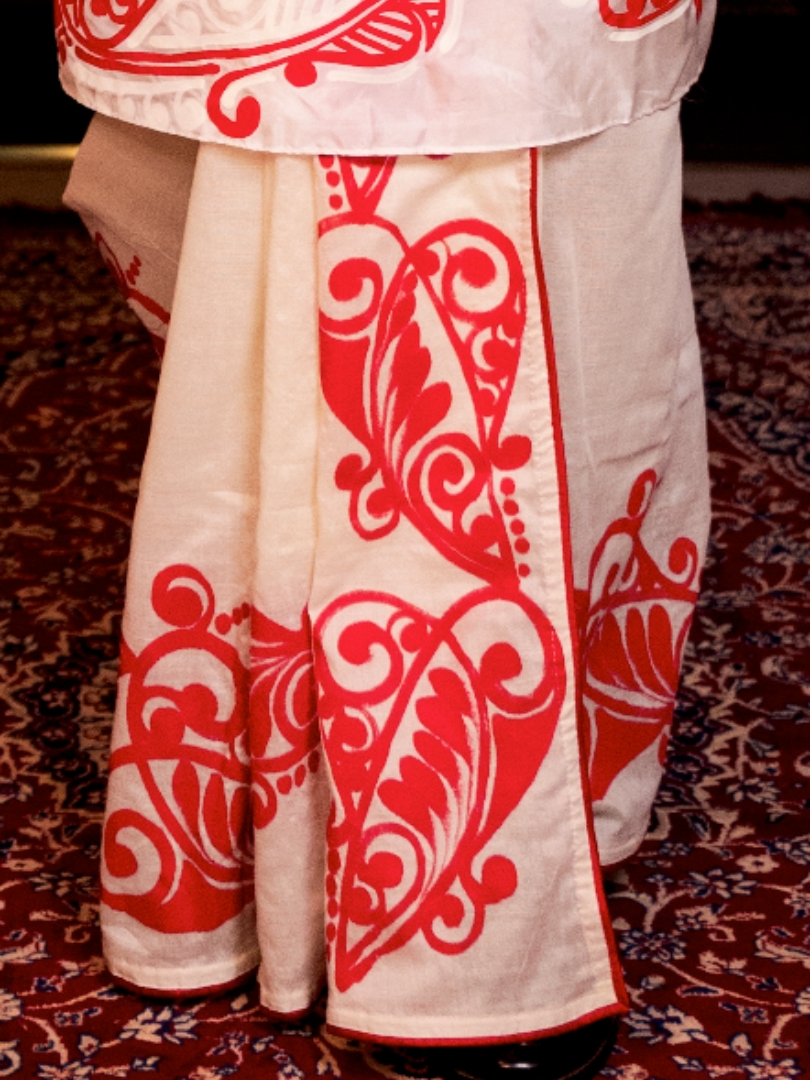 Red alpona on white Dhoti